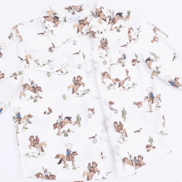 A white long-sleeve button-up shirt with a cowboy and western-themed print featuring brown horses, riders, and small desert motifs, laid flat on a white background.