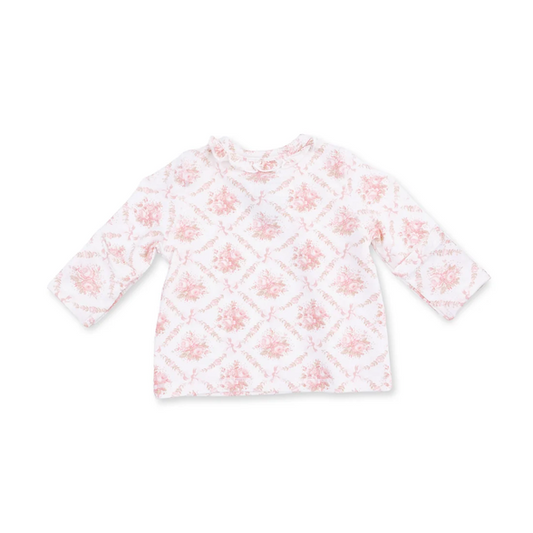 A long-sleeve baby top in white with a light pink floral and diamond pattern, laid flat against a white background.