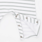 Close-up of a white and light gray striped baby garment with a folded sleeve or cuff showing metal snap buttons on a white background.
