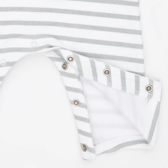 Close-up of a white and light gray striped baby garment with a folded sleeve or cuff showing metal snap buttons on a white background.
