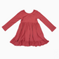 A dusty rose long-sleeve baby dress with a gathered waist and ruffled hem, laid flat on a white background.