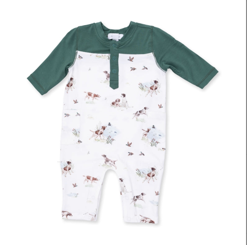 A baby long-sleeve romper with a white body covered in a hunting dog print, and dark green sleeves and a matching green Henley-style collar.
