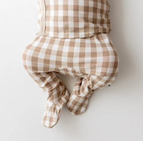 A baby footed sleeper or onesie in a beige and white gingham check pattern, shown from the back against a plain white background.
