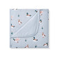 A folded light blue baby blanket or swaddle featuring a printed pattern of mallards and reeds, with one corner folded over to show the soft fabric texture.