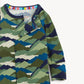 A close-up of a children's long-sleeve top with a mountain-wave camouflage pattern in shades of green, blue, navy, and beige. The garment features a dark navy collar with a colorful striped inner trim and a small brand label visible inside the neckline.