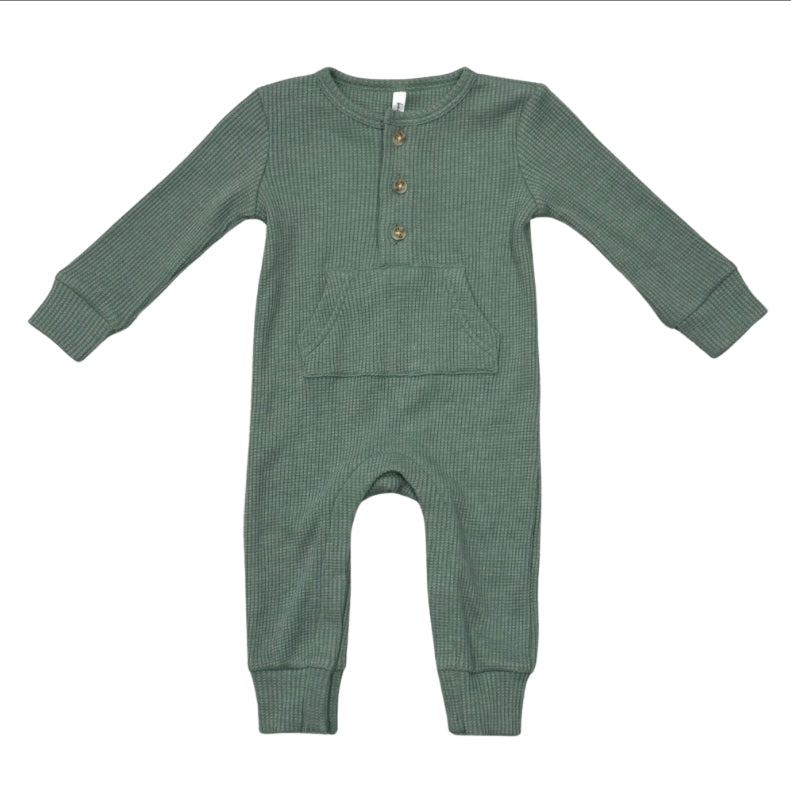 A sage green ribbed knit baby jumpsuit with long sleeves, a buttoned henley neckline, and front patch pockets, shown flat on a white background.