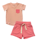 Pink t-shirt with a pocket and pink shorts on a white background