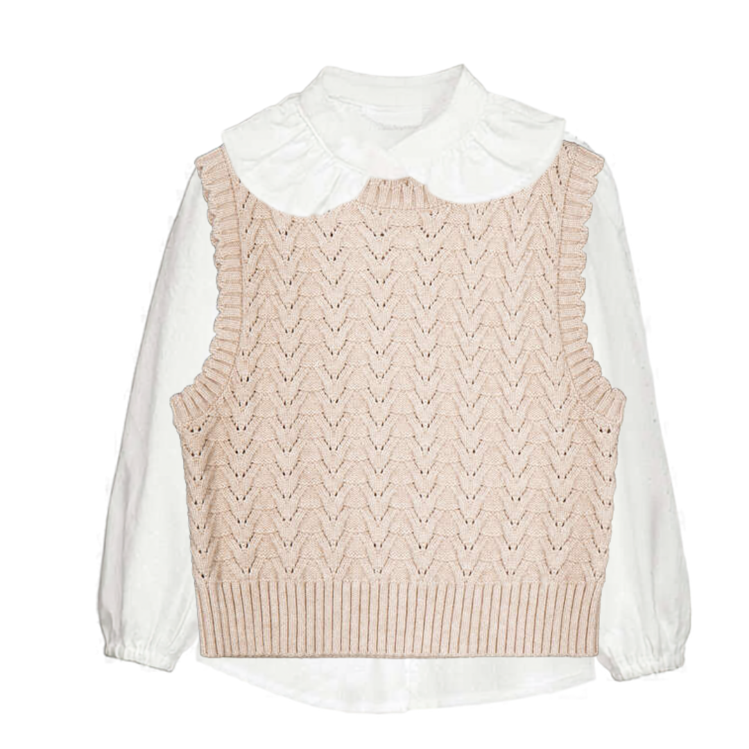 knit sweater vest layered with a white blouse