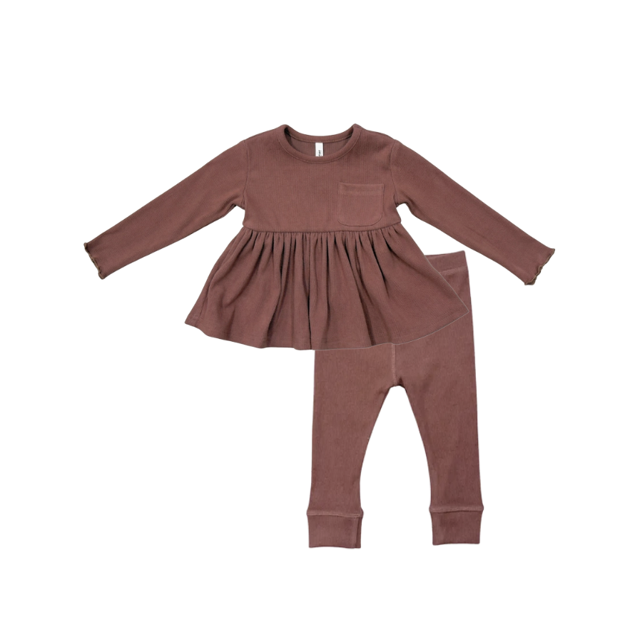 A toddler girl's two-piece clothing set in a dusty rose-brown color, featuring a long-sleeve peplum-style top with a chest pocket and matching ribbed leggings, laid flat on a white background.