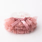 Pink tutu skirt with a bow on a white background