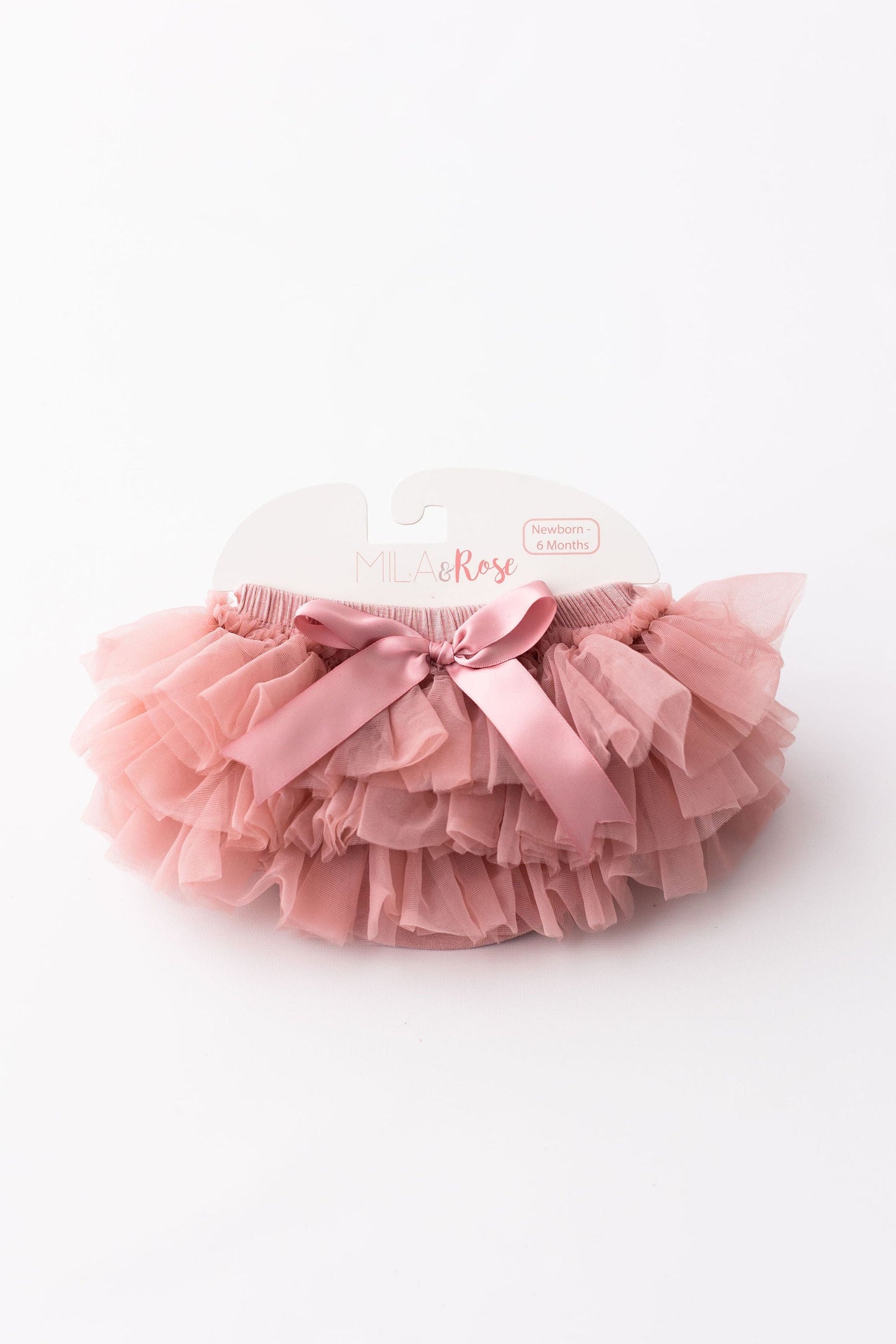 Pink tutu skirt with a bow on a white background