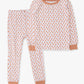 A two-piece children's pajama set featuring a long-sleeve top and matching pants in white with a repeating peach-orange leaf pattern, finished with solid peach-orange ribbed trim at the collar, cuffs, and knee patches.