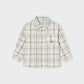 A long-sleeve button-up shirt for kids, featuring a beige and white plaid pattern with thin green lines
