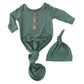 Green baby onesie with buttons and matching hat 