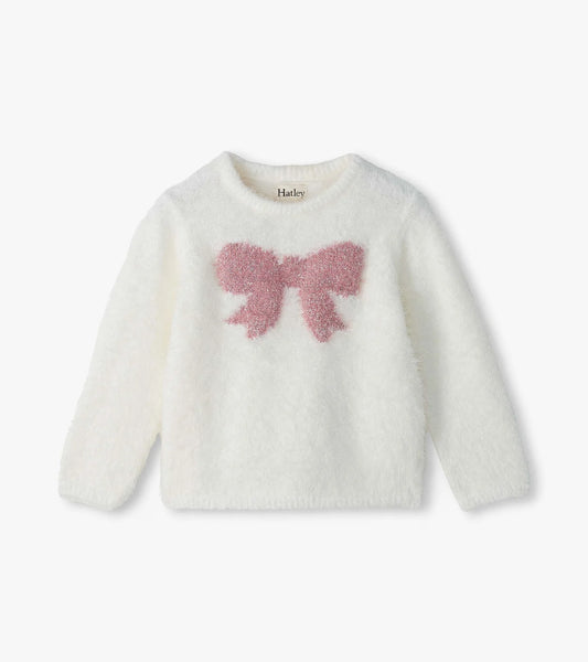 A white fuzzy long-sleeve baby sweater with a pink textured bow motif on the chest, displayed against a clean white background.