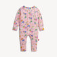 A pink baby long-sleeve footless one-piece jumpsuit with an all-over colorful whimsical print of books, pencils, and abstract shapes, shown flat on a light off-white background.