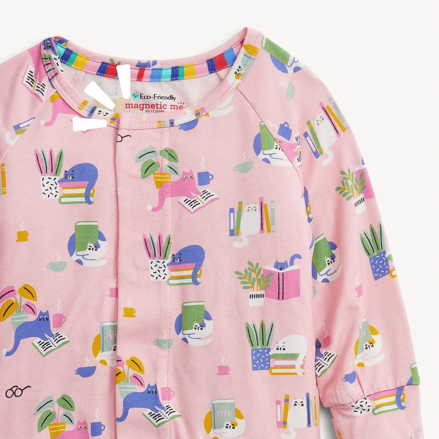 A close-up of a pink long-sleeve baby romper featuring a colorful cartoon print of cats, books, plants, and pencils, with a snap-button front and elastic collar.