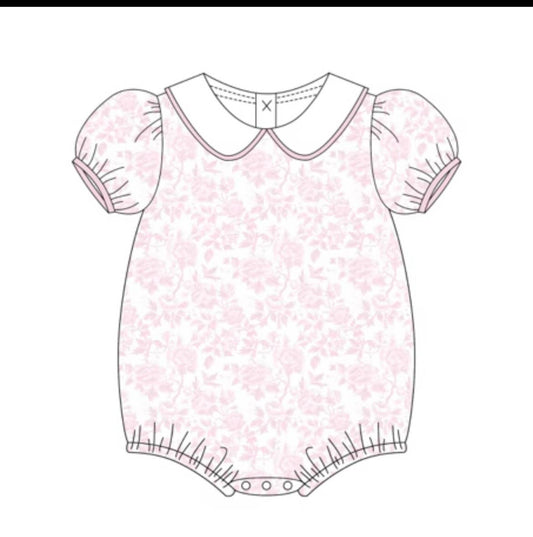 A flat line-art illustration of a baby bodysuit or romper with short puff sleeves, a Peter Pan collar, and a light pink floral pattern on a white background.