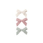 Three hair bows in white, pink, and light green
