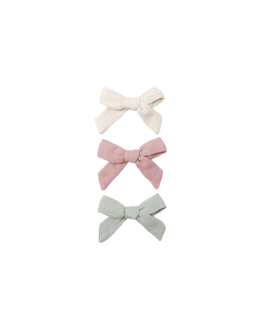 Three hair bows in white, pink, and light green