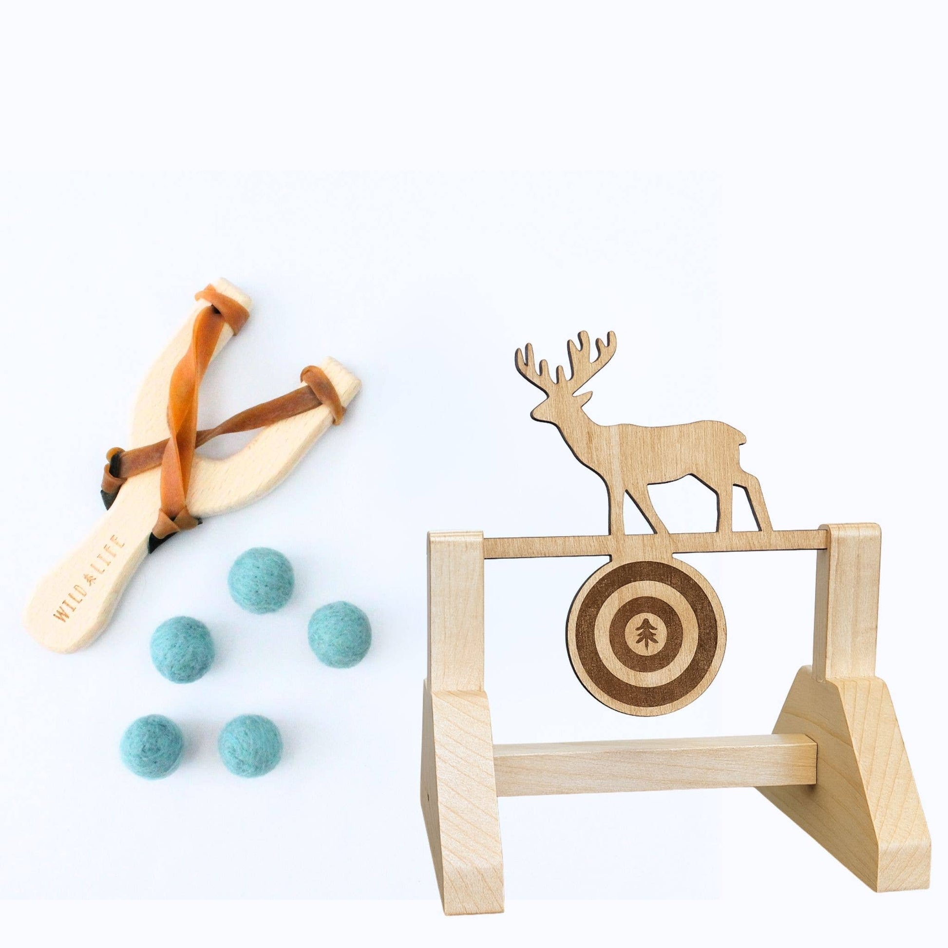 Wooden slingshot with felt balls and target stand with deer design on a white background