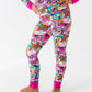 Person wearing a colorful pajama set with cartoon characters on a white background