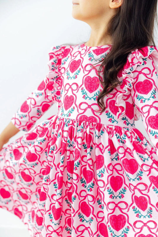 a pink dress with heart and bow pattern 