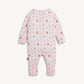 A baby long-sleeve footless romper in light pink with a repeating pattern of teddy bears, snowmen, and snow globes in brown, orange, and purple, shown against a plain off-white background.