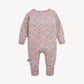 A baby long-sleeve footless one-piece jumpsuit with a dense multicolor floral print on a light pinkish-beige background, featuring a contrasting pink collar.