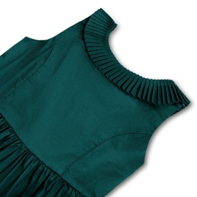 Close-up of a dark teal green sleeveless top or dress with a pleated ruffled neckline on a white background.