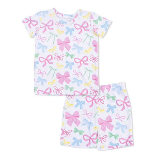 Children's pajama set with bow pattern on a white background