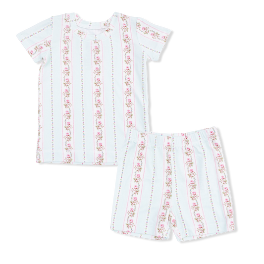 White children's pajamas with red floral on a white background