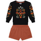 Black sweatshirt with floral patterns and orange shorts