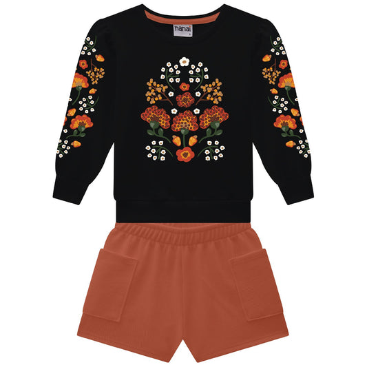 Black sweatshirt with floral patterns and orange shorts