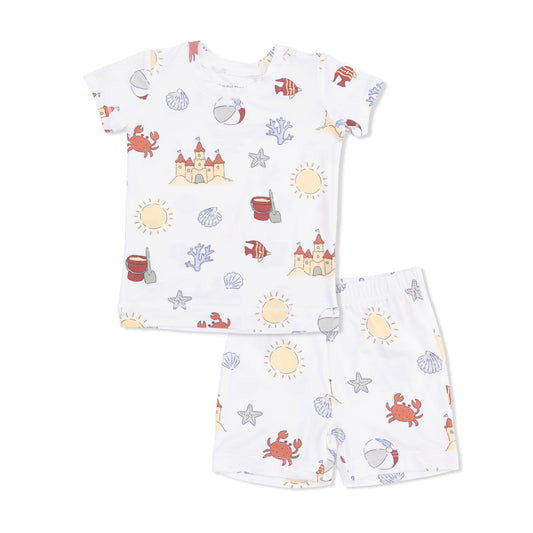 Children's pajama set with beach-themed pattern on a white background