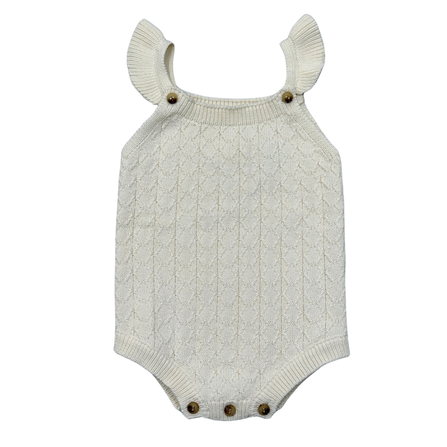 Knitted baby romper with ruffled shoulder straps on a white background