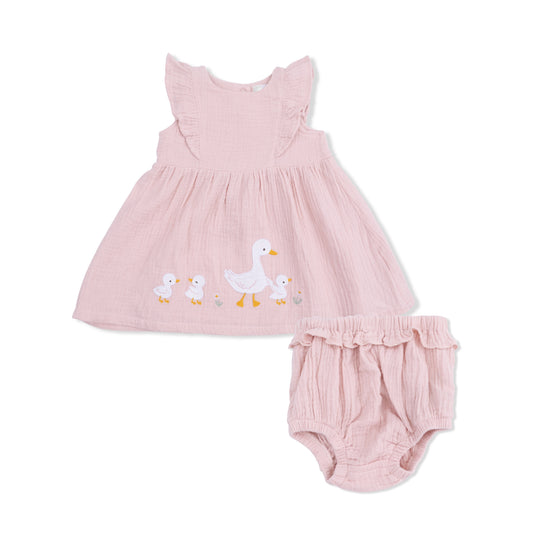 Pink baby dress with duck design and matching bloomers on a white background