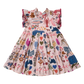 A pink tiered dress with a smocked bodice and ruffled shoulders, featuring a colorful patchwork print of sea creatures, hearts, stars, and botanical motifs, shown against a plain white background.